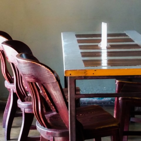 Table & chairs in the sunlight @ the Dive Bar, Austin TX